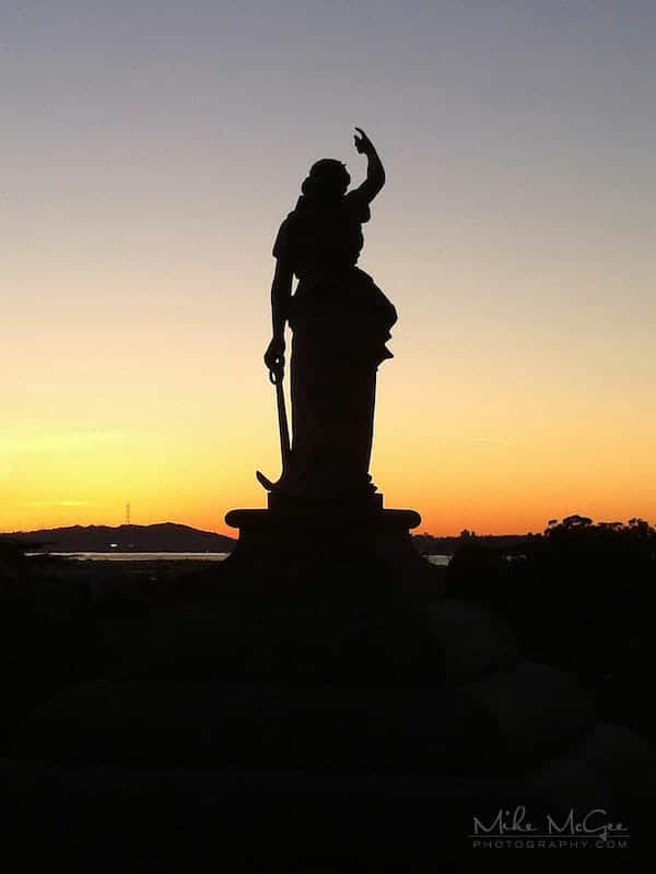 Stone statue taken at sunset in the cemetery hills of Oakland, California