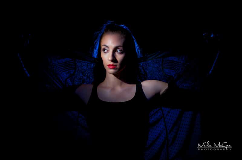 Model Credit: Ariele S. Dramatic lighting themed portrait with a colored gel dual lighting setup. Location: Oakland, California.